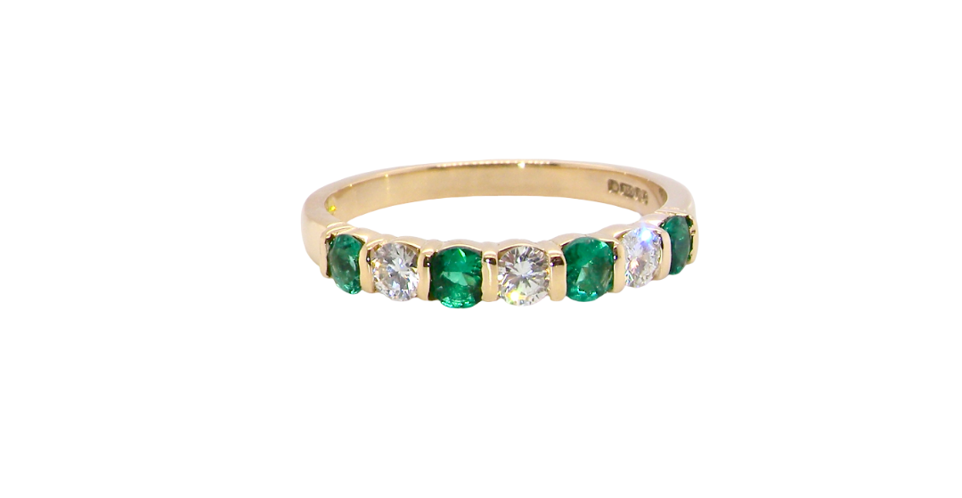 Emerald and diamond half eternity ring