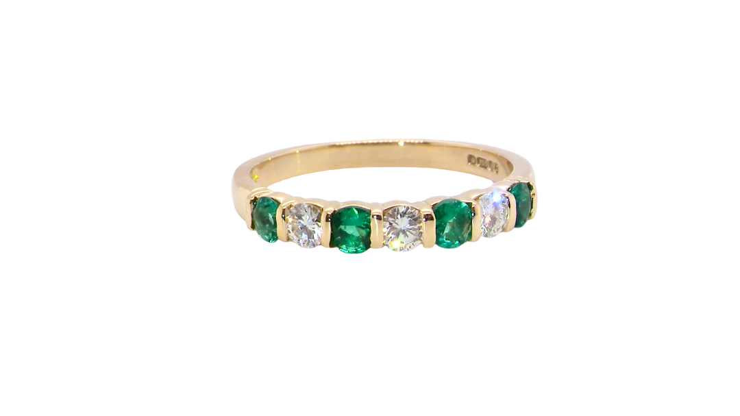 Emerald and diamond half eternity ring