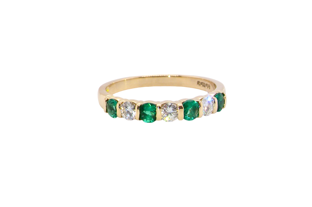 Emerald and diamond half eternity ring