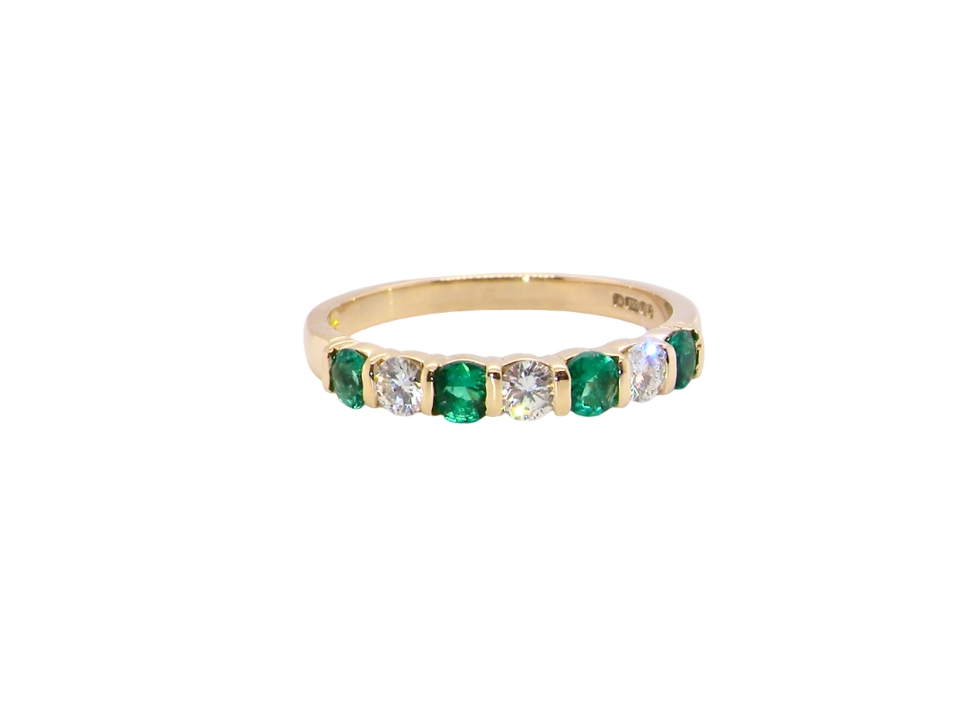 Emerald and diamond half eternity ring