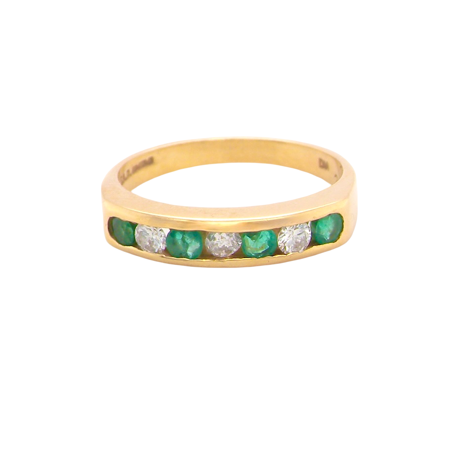 An 18 carat yellow gold half hoop eternity ring. Set with four round emeralds, each 3mm, and alternate set with brilliant cut white diamonds, each 3mm (total est 0.30 carats)