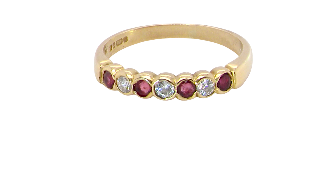 An 18 carat yellow gold half hoop eternity ring. Set with four rubies, 3mm each.
Set with alternate diamonds, each 3mm (0.10 carats each) colour i-j, clarity Si.