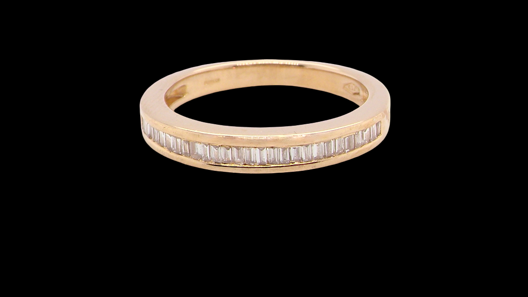 An 18 carat yellow gold half hoop eternity ring.
Set with thirty baguette cut diamonds,