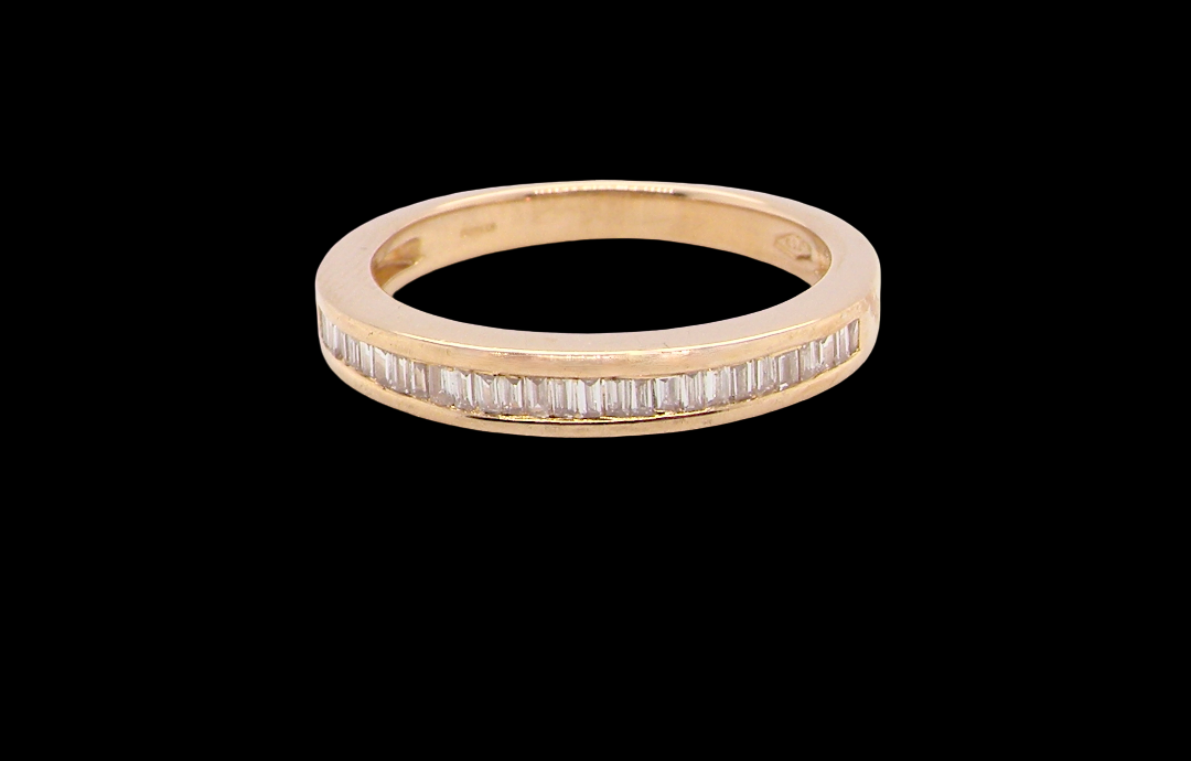 An 18 carat yellow gold half hoop eternity ring.
Set with thirty baguette cut diamonds,