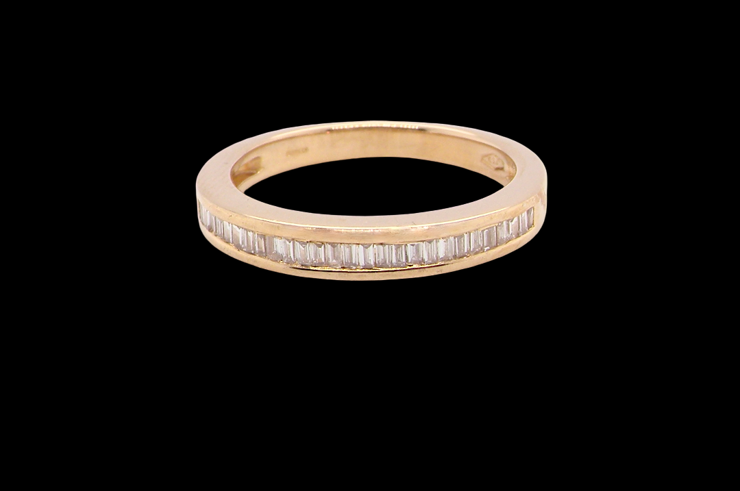 An 18 carat yellow gold half hoop eternity ring.
Set with thirty baguette cut diamonds,