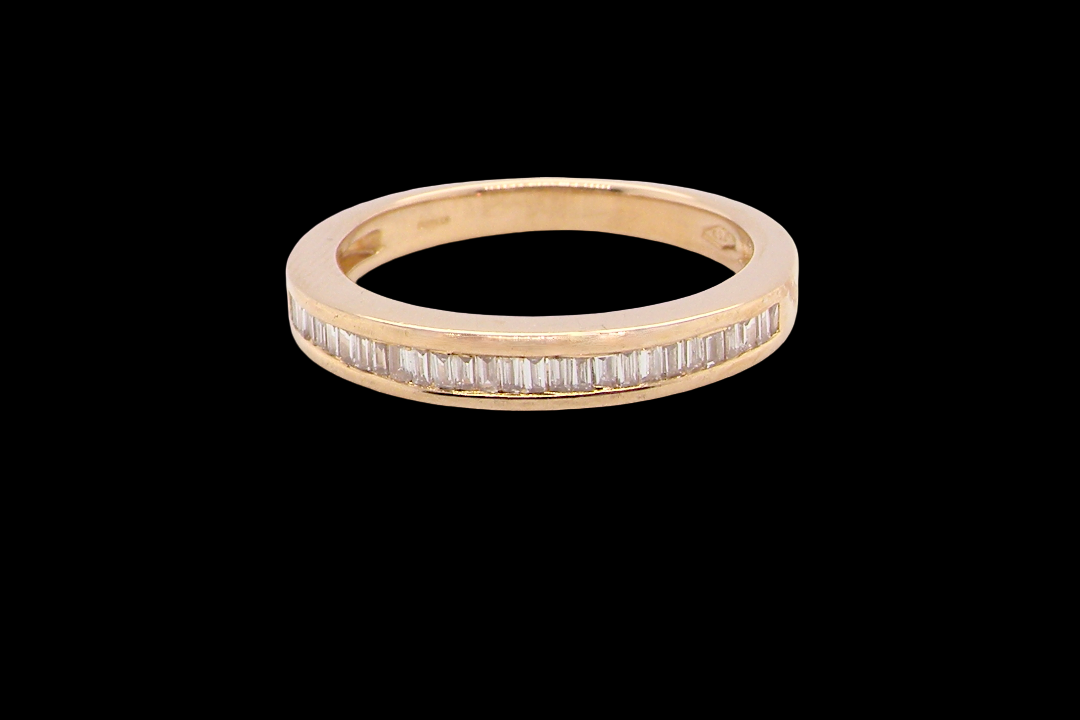 An 18 carat yellow gold half hoop eternity ring.
Set with thirty baguette cut diamonds,