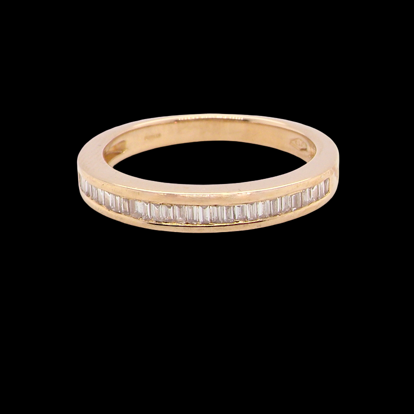 An 18 carat yellow gold half hoop eternity ring.
Set with thirty baguette cut diamonds,