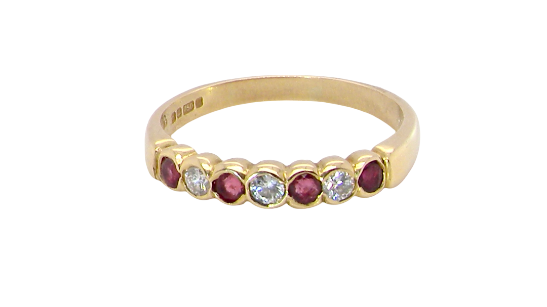 Yellow gold ruby and diamond half hoop ring