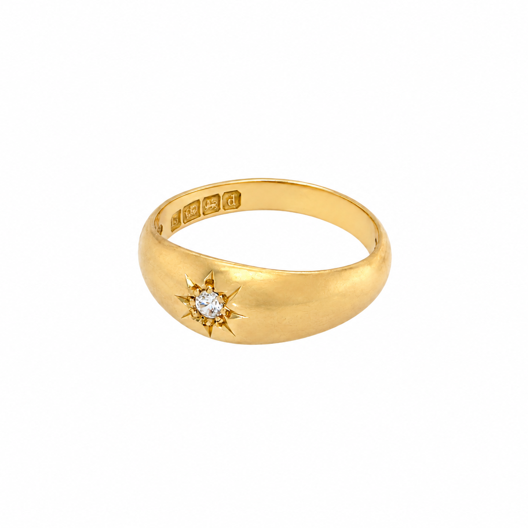 An 18 carat yellow gold ring, sometimes referred to as a 'gypsy' ring. The diamond measures 2.4mm (0.05 carats) star set.