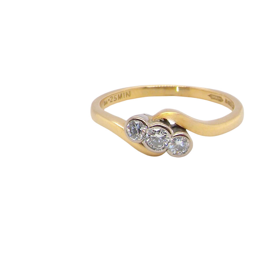 An 18 carat yellow gold three stone ring, cross over style, and set with brilliant cut white diamonds.
Centre stone 3mm (0.10 carats)