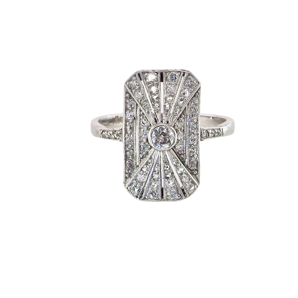 An Art Deco panel shaped cluster ring. The head measures 16x10mm, depth 3.4mm, and has two fan shaped designs that feature above and below a brilliant cut white diamond centre stone which measures 3.4mm (0.15 carats est)