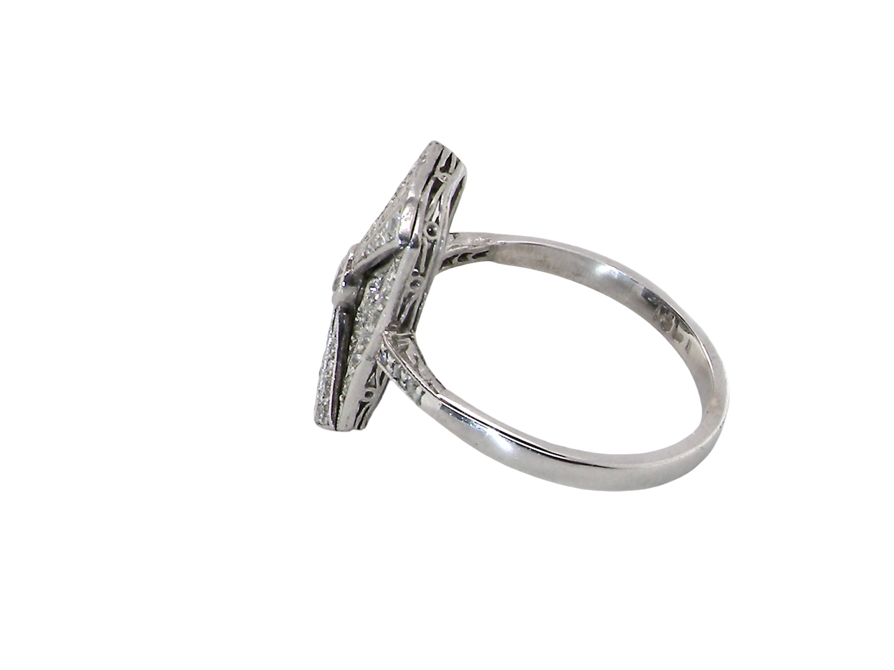An Art Deco panel shaped cluster ring. The head measures 16x10mm, depth 3.4mm, and has two fan shaped designs that feature above and below a brilliant cut white diamond centre stone which measures 3.4mm (0.15 carats est)
side