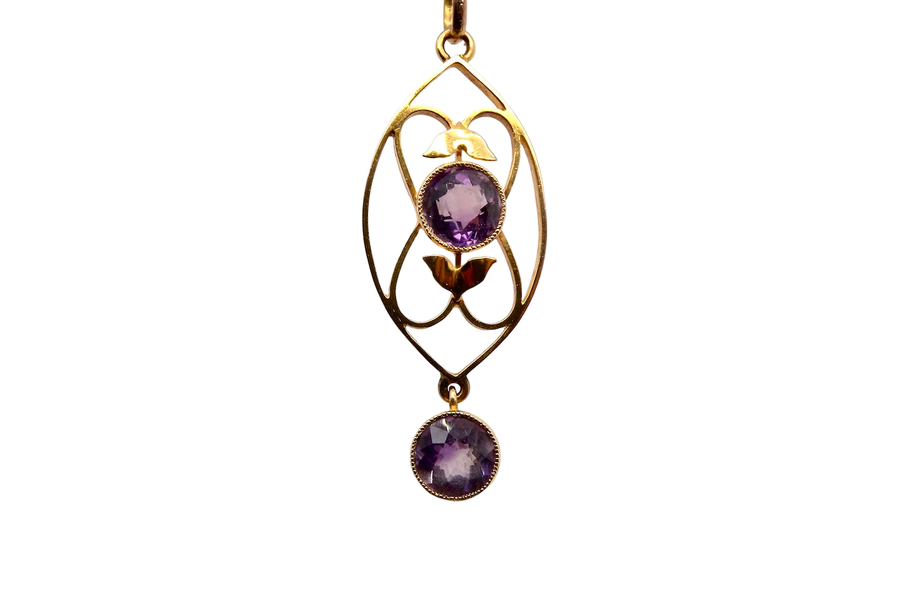 An Edwardian pendant set with two amethyst