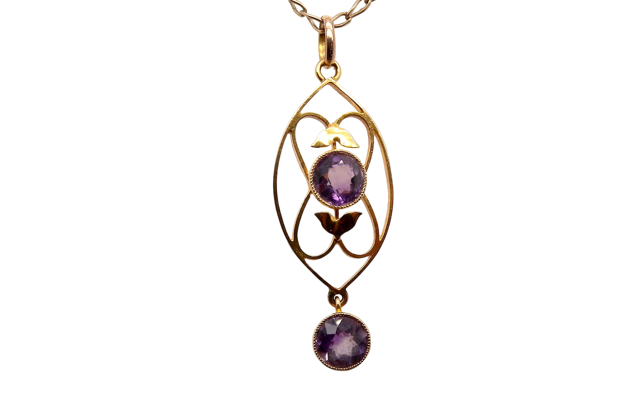 An Edwardian pendant set with two amethyst gemstones