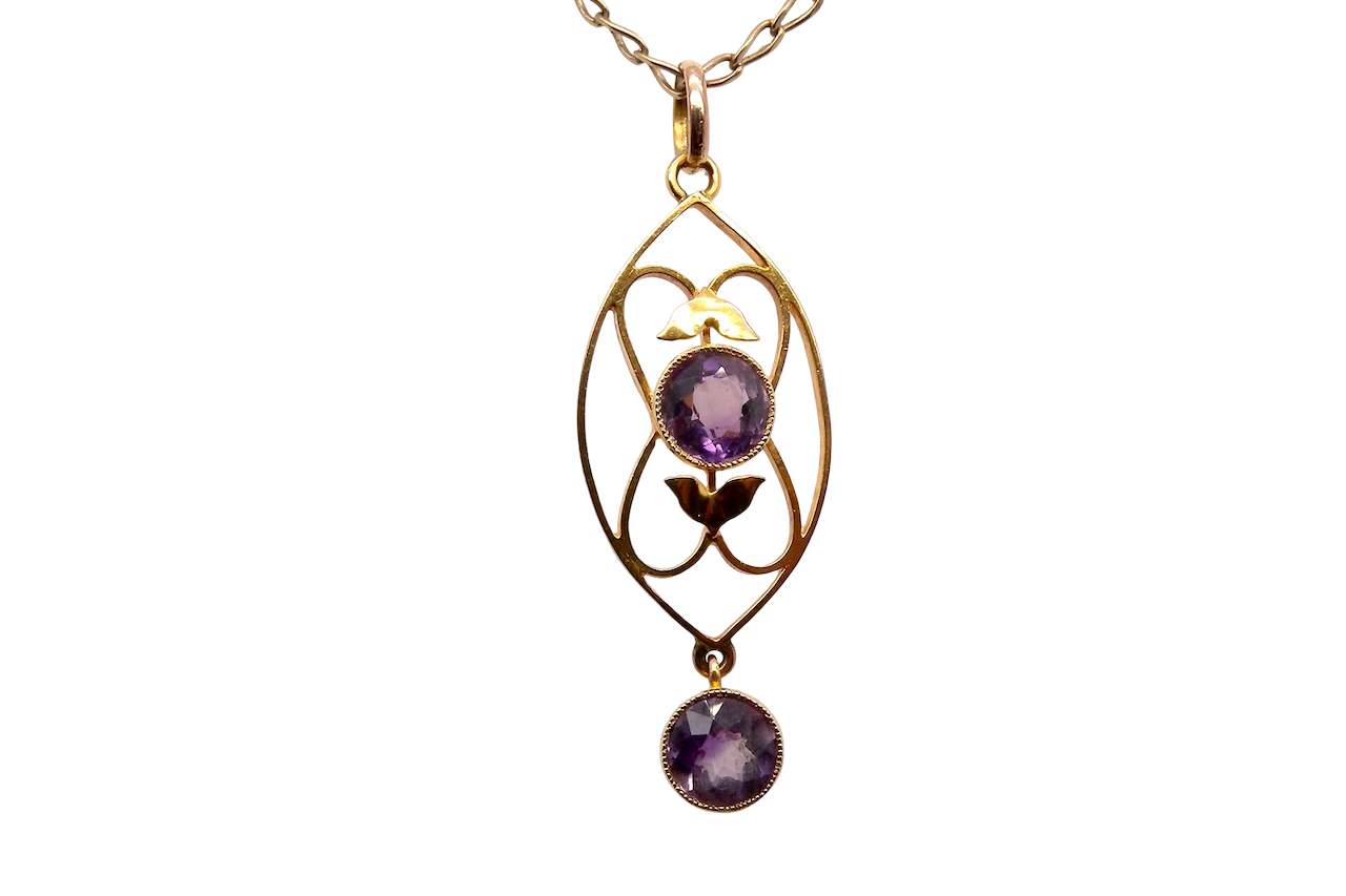 An Edwardian pendant set with two amethyst gemstones
