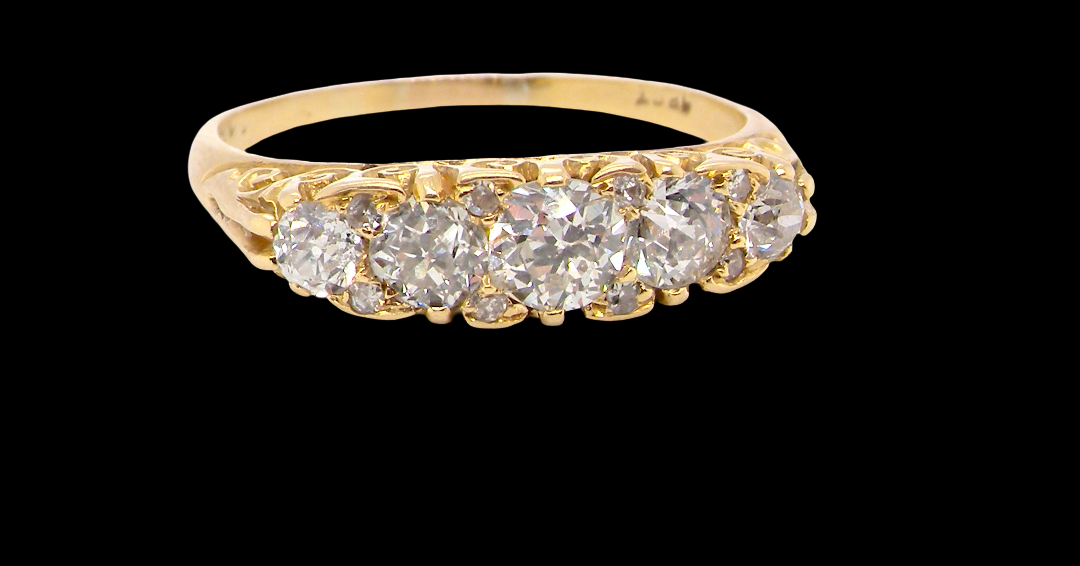 An antique boat shaped five stone ring. Set with five old cut white diamonds. Centre 5mm (0.45-0.50 carats) each side a 4mm stone, at each end a 2.4mm stone. Total diamond content estimated at one carat.