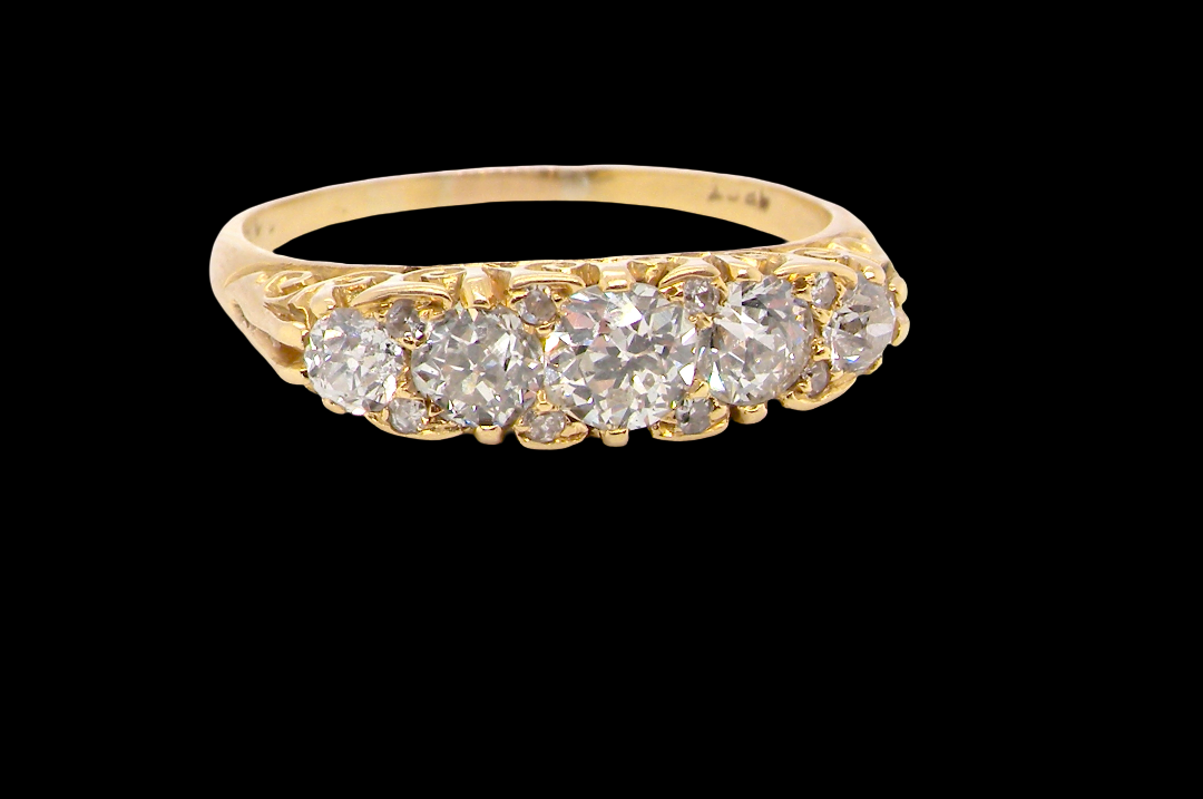 An antique boat shaped five stone ring. Set with five old cut white diamonds. Centre 5mm (0.45-0.50 carats) each side a 4mm stone, at each end a 2.4mm stone. Total diamond content estimated at one carat.