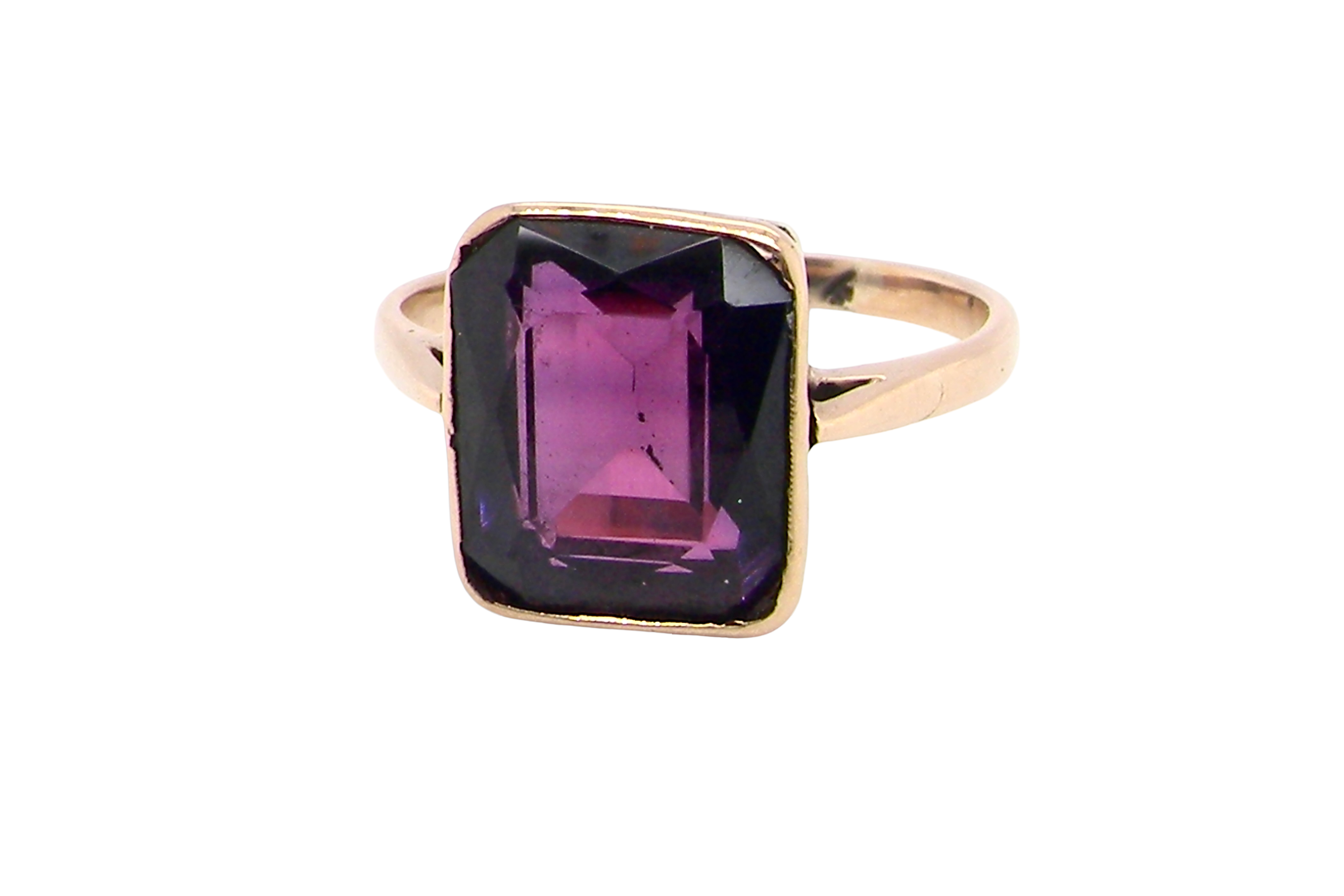An antique dress ring that features a rectangular cut amethyst. Very dark purple, measures 12x10mm.