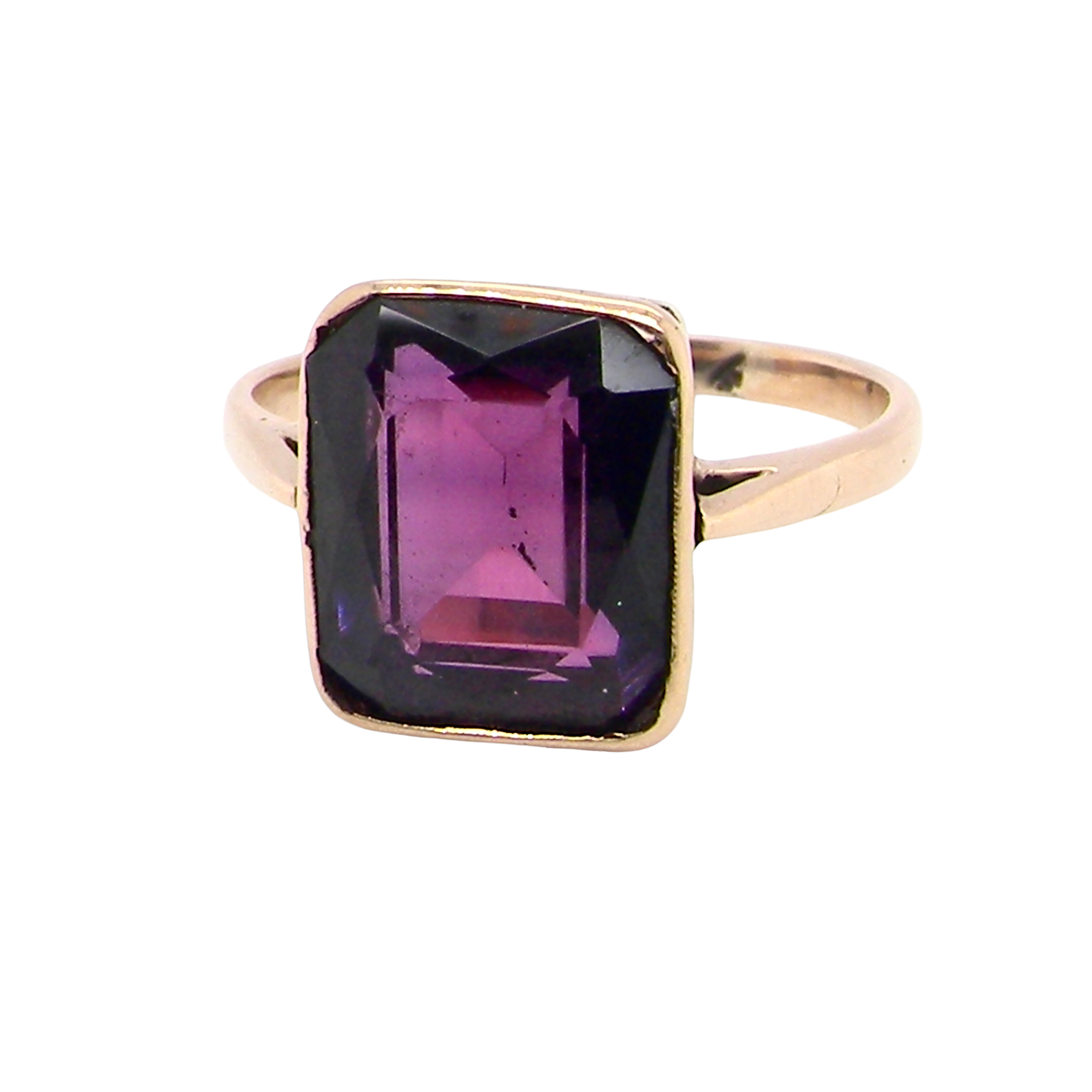 An antique dress ring that features a rectangular cut amethyst. Very dark purple, measures 12x10mm.