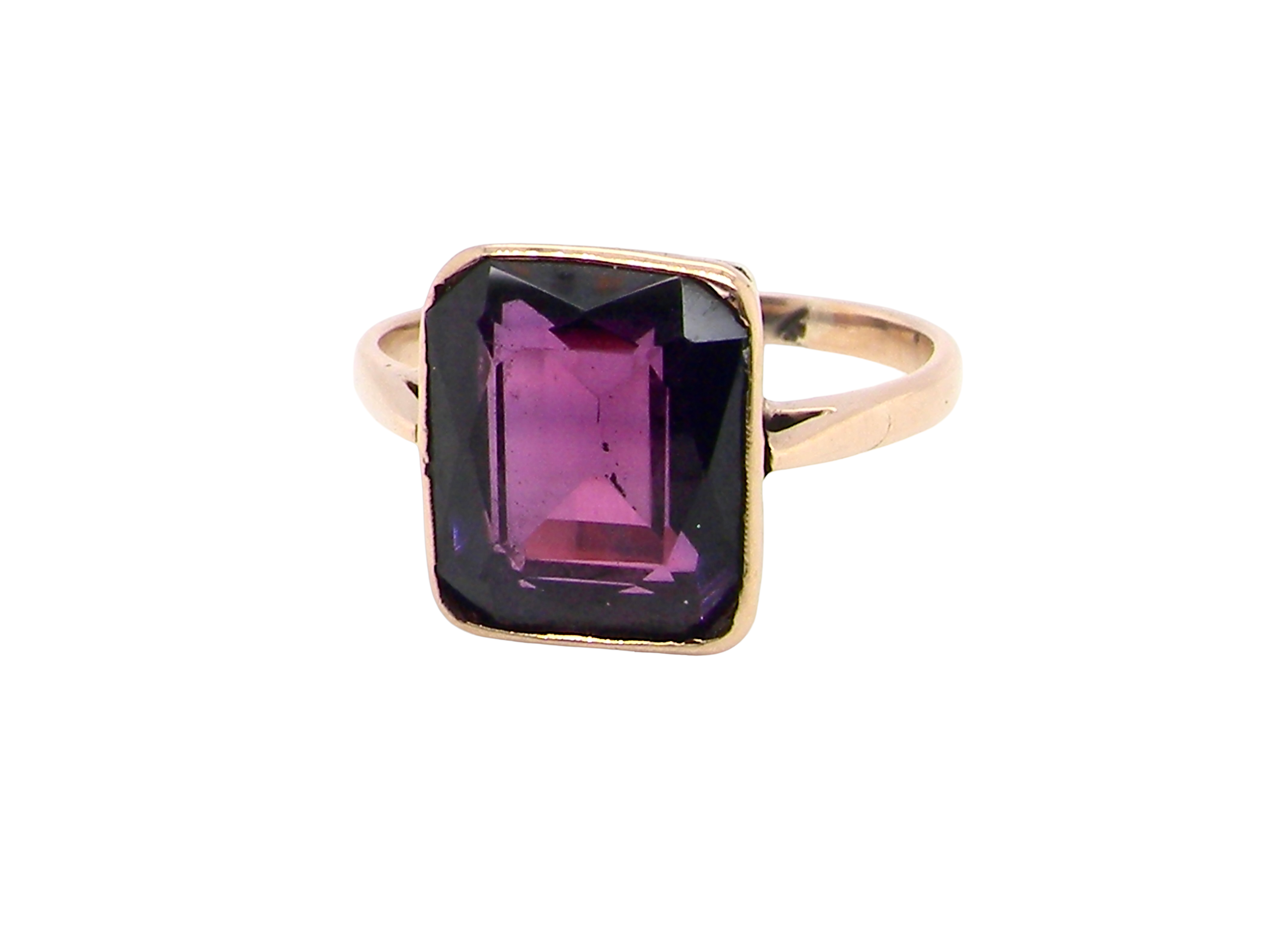 An antique dress ring that features a rectangular cut amethyst. Very dark purple, measures 12x10mm.