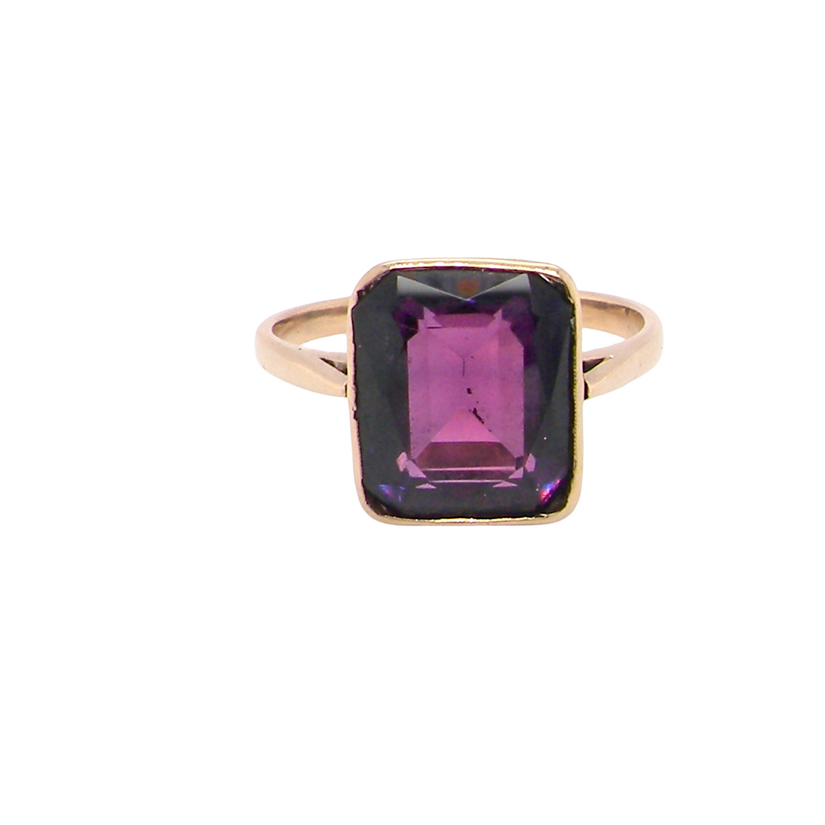 An antique dress ring that features a rectangular cut amethyst. Very dark purple, measures 12x10mm. Rim setting.