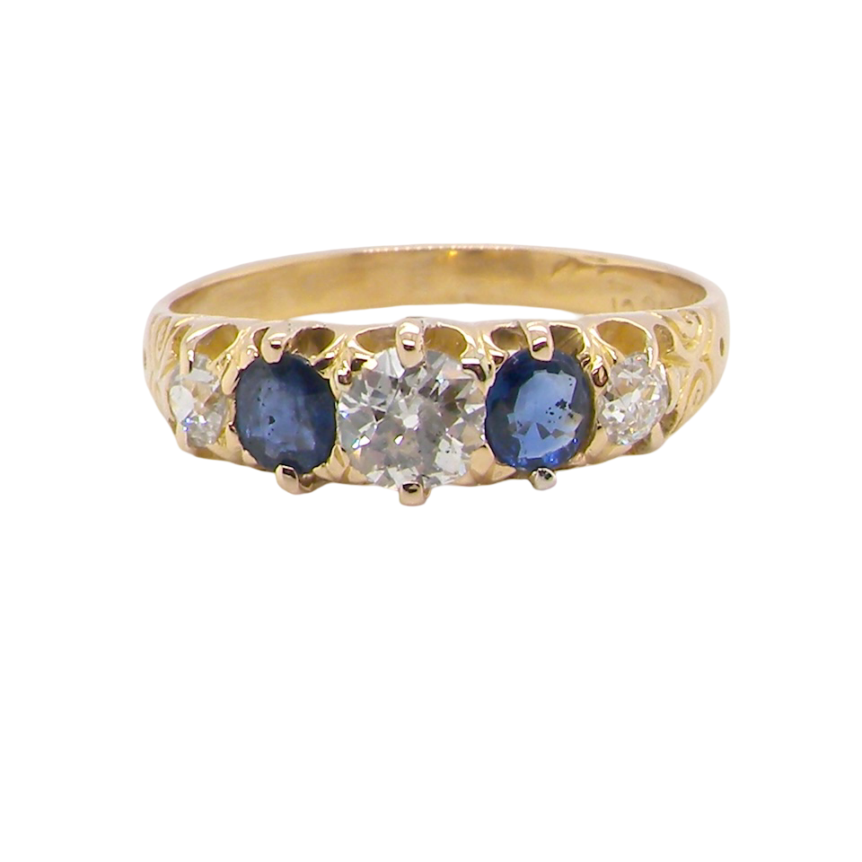 An antique ring from the early years of the 20th century. Centre stone 5mm diameter (0.50 carats) Colour H-j, clarity Si. Each side blue sapphire 4mm diameter.