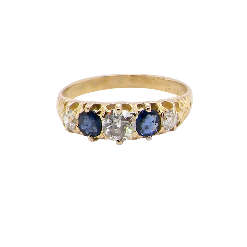 An antique ring from the early years of the 20th century. Centre stone 5mm diameter (0.50 carats) Colour H-j, clarity Si. Each side a mid colour blue sapphire 4mm diameter.