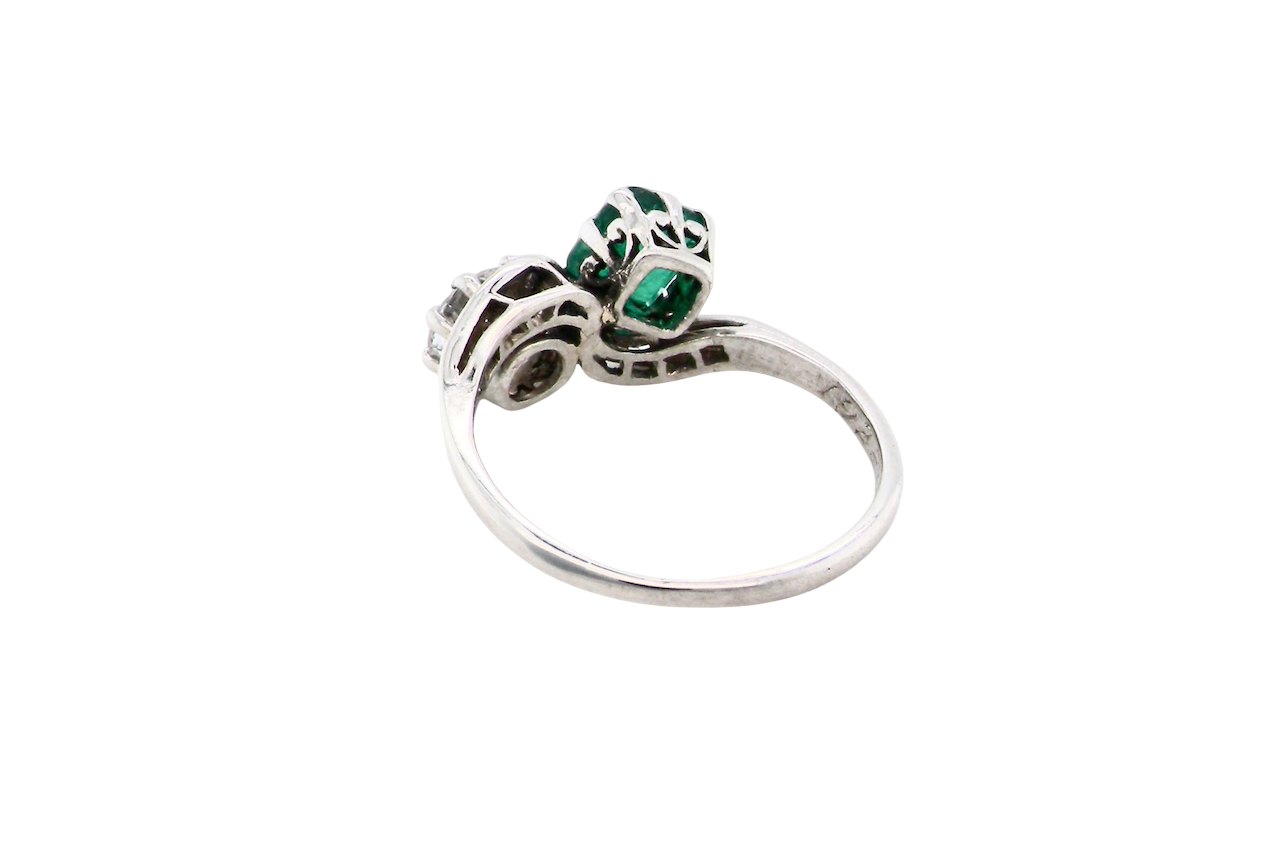An antique two stone Emerald and Diamond ring
