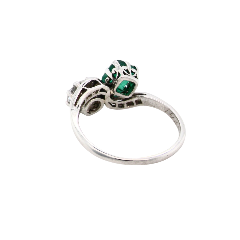 An antique two stone Emerald and Diamond ring
