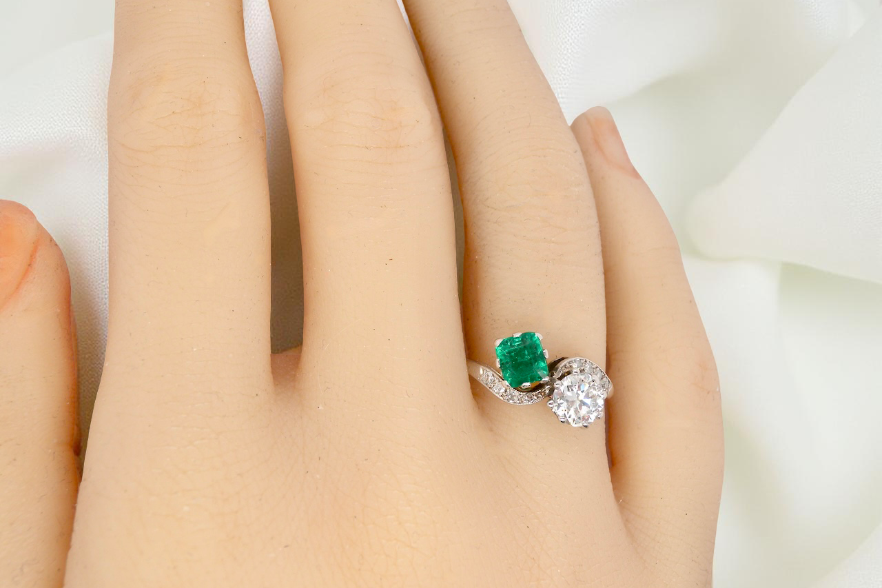 An antique two stone Emerald and Diamond ring