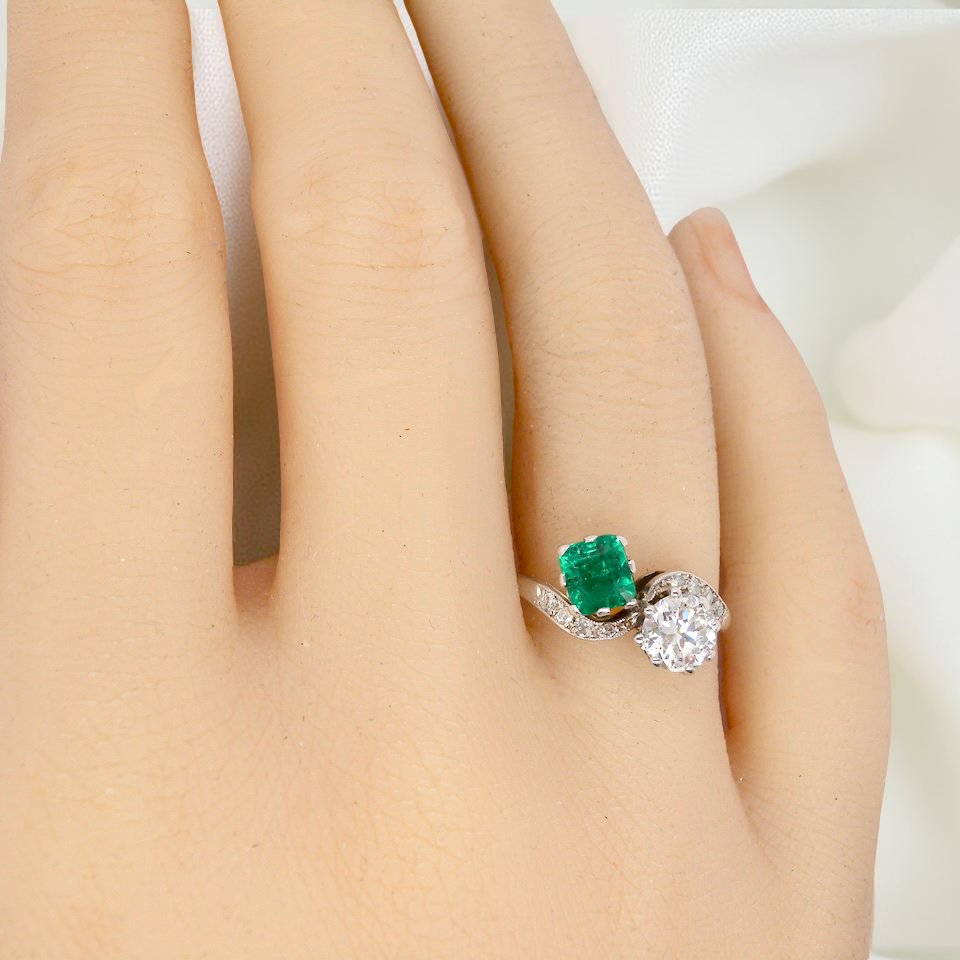 An antique two stone Emerald and Diamond ring