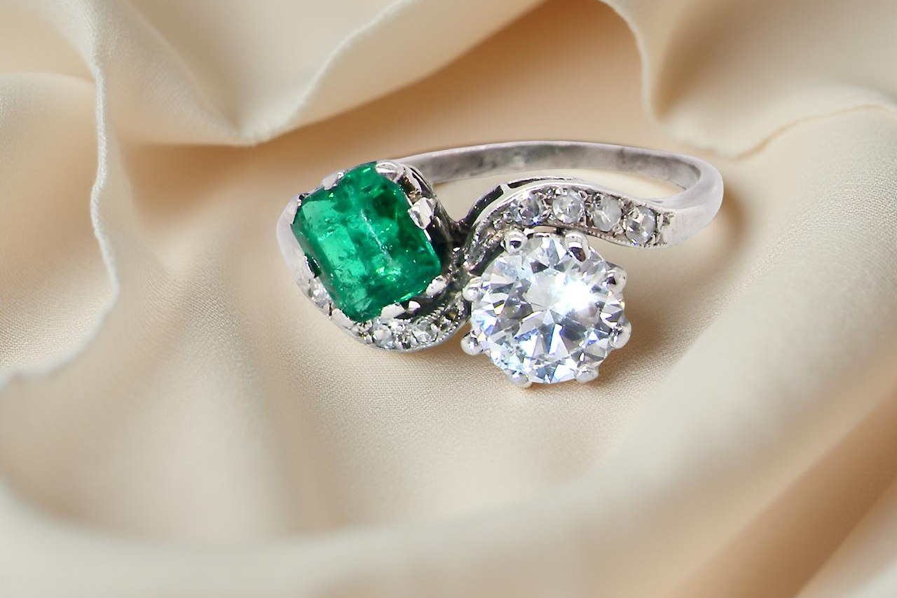 An antique two stone Emerald and Diamond ring