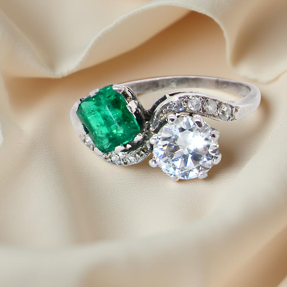 An antique two stone Emerald and Diamond ring
