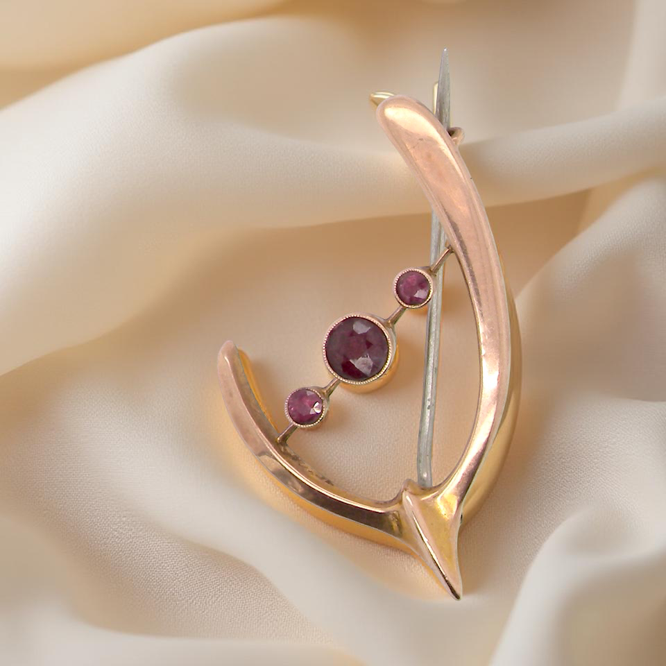 An antique wishbone shaped brooch