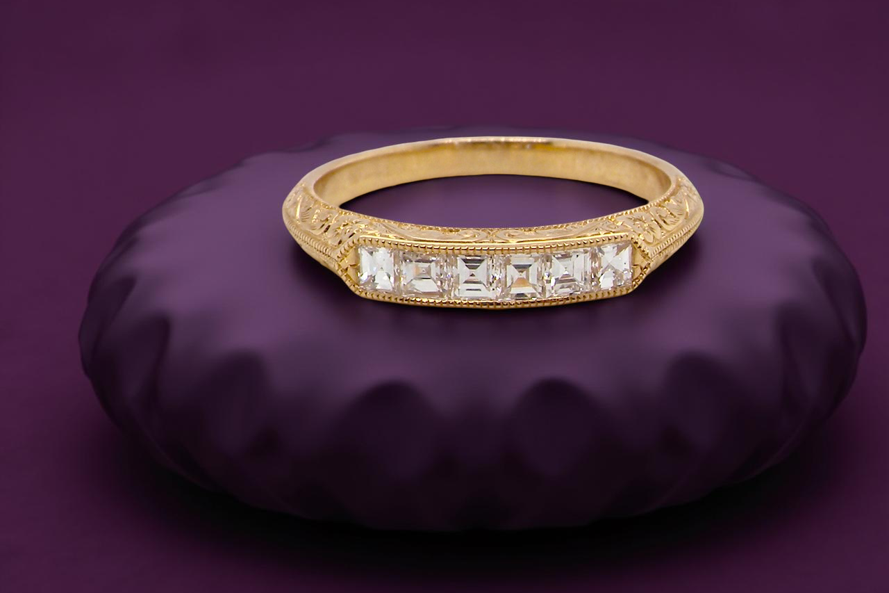 An attractive half hoop diamond eternity ring. Set with six step cut white diamonds, tbhat sit side by side,