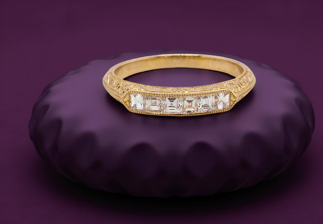 An attractive half hoop diamond eternity ring. Set with six step cut white diamonds, tbhat sit side by side,