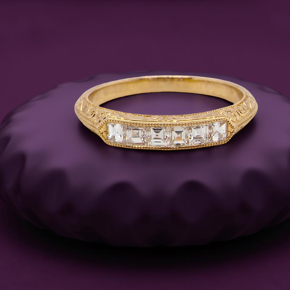An attractive half hoop diamond eternity ring. Set with six step cut white diamonds, tbhat sit side by side,