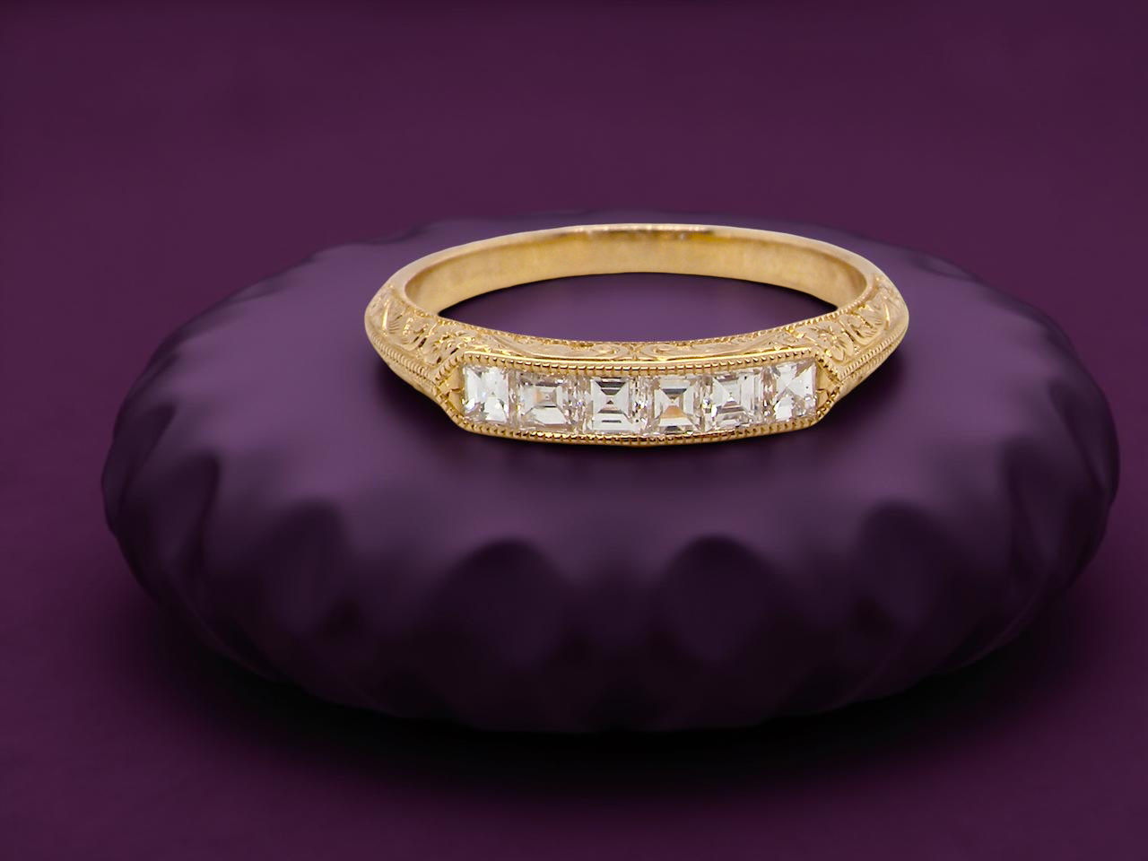 An attractive half hoop diamond eternity ring. Set with six step cut white diamonds, tbhat sit side by side,