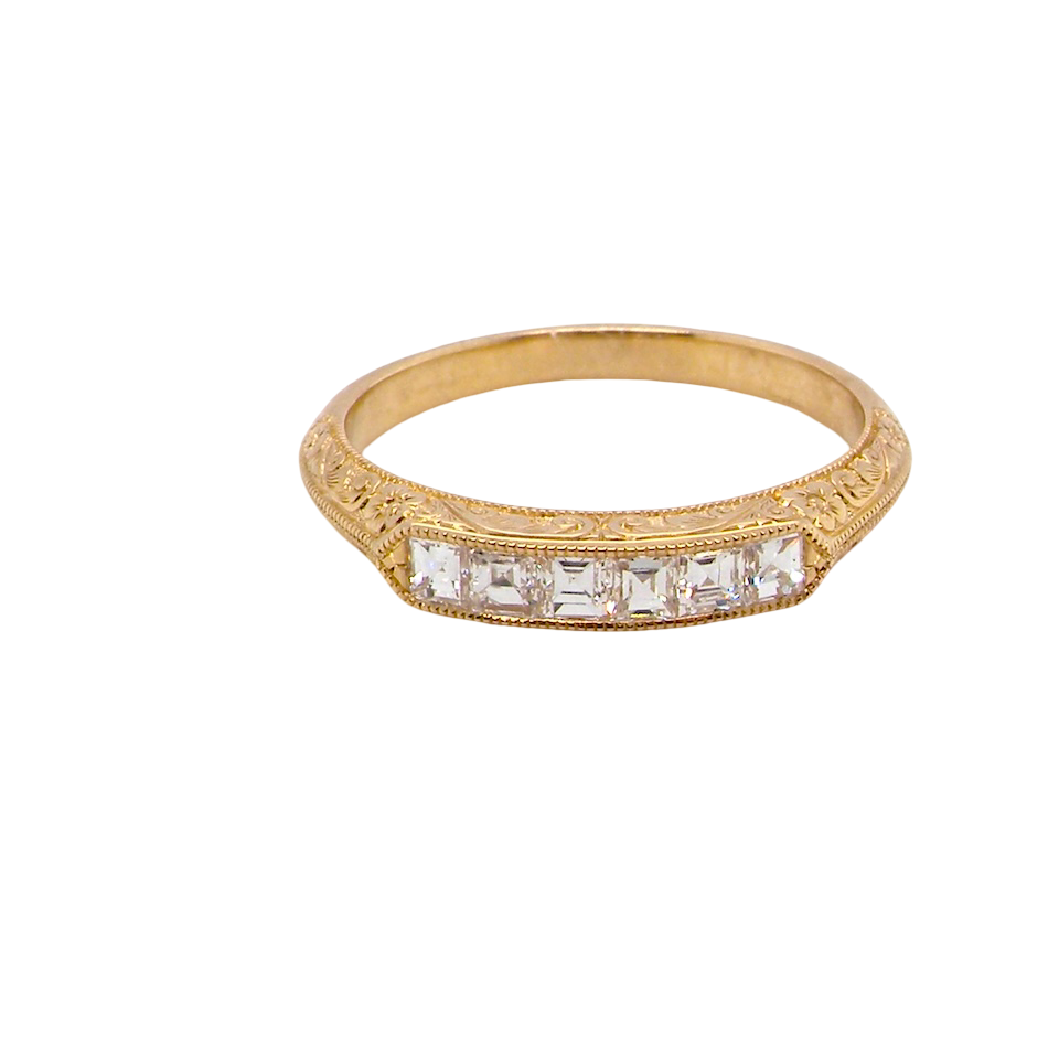 An attractive half hoop diamond eternity ring. Set with six step cut white diamonds, tbhat sit side by side, the colour estimated at H-i, clarity Si.