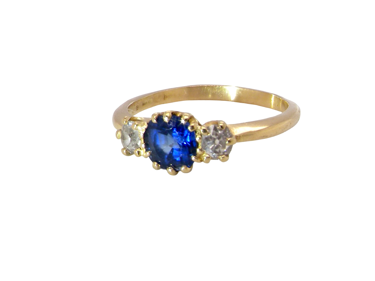 An early 20th-century trilogy ring set with a cornflower blue central sapphire,