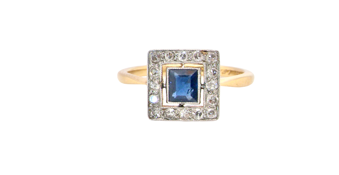 An early 20th century square cluster ring. Features a square inky black blue sapphire, 4x4mm (est 0.25 carats)