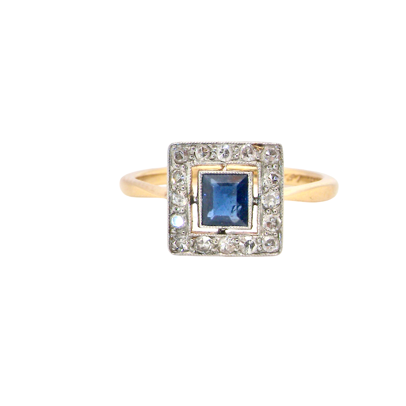 An early 20th century square cluster ring. Features a square inky black blue sapphire, 4x4mm (est 0.25 carats)
