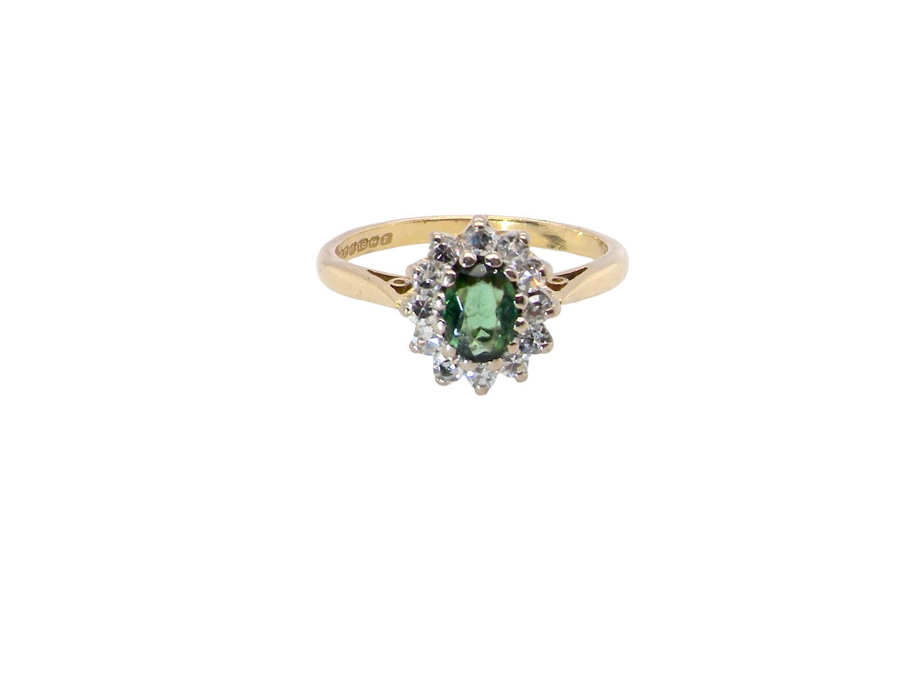 An elegant 18 carat gold cluster ring featuring a beautifully proportioned 6 × 4mm green tourmaline