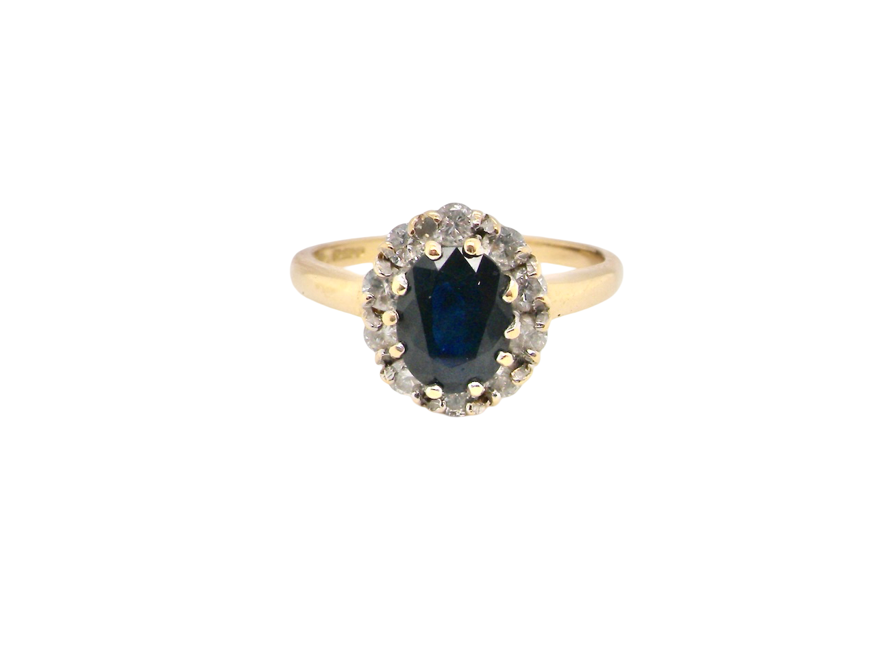 An elegant 18 carat gold cluster ring featuring a striking inky dark blue sapphire at its centre.