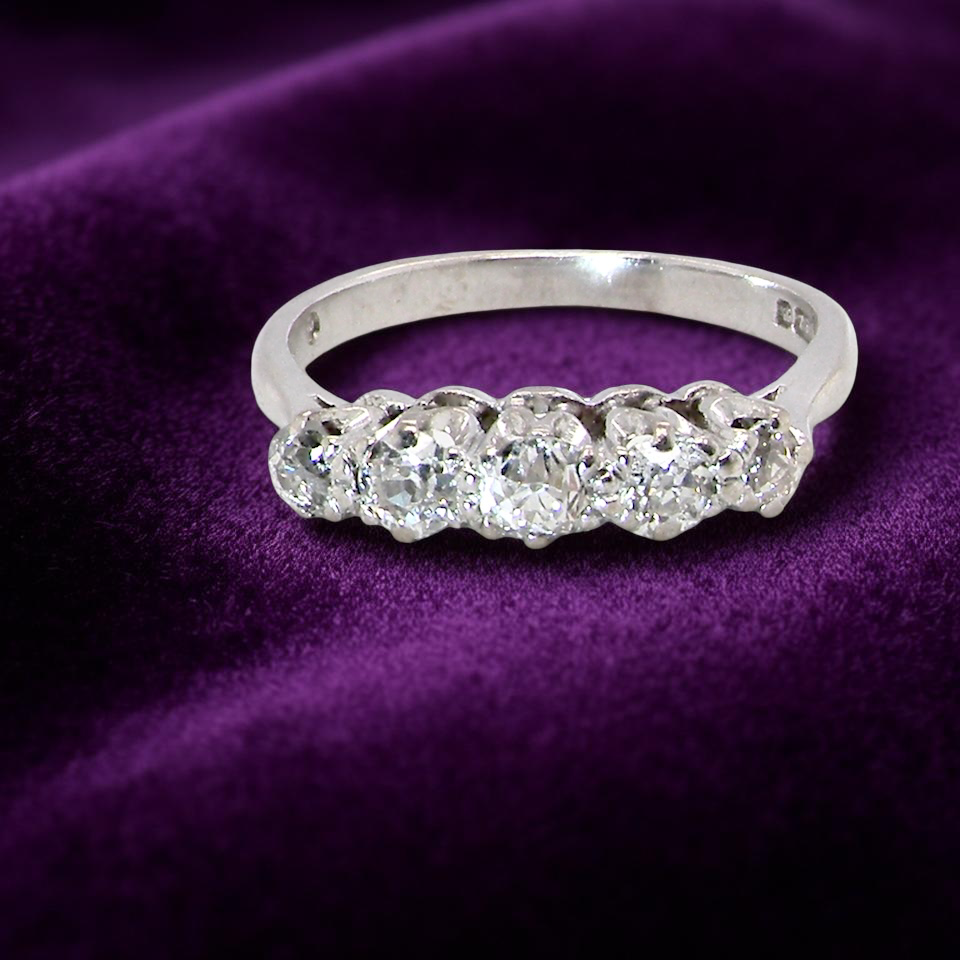 An elegant 18 carat white gold five-stone ring set with brilliant-cut white diamonds. The centre diamond measures 3.4mm, flanked by two 3.0mm stones and finished with 2.8mm diamonds at each end, creating a balanced graduated design.