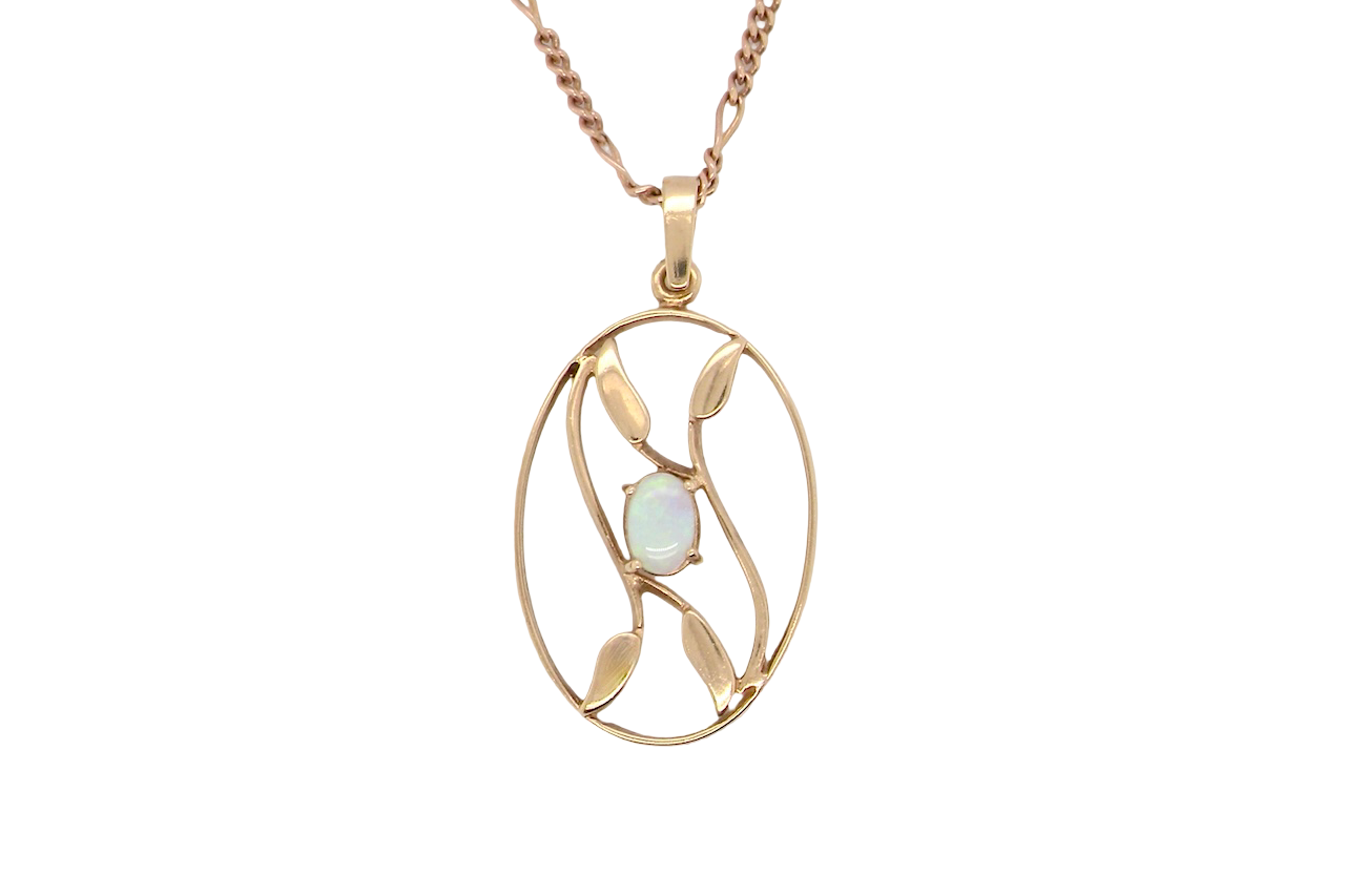 An elegant Art Deco style pendant featuring a beautiful oval opal measuring 6 × 4 mm,