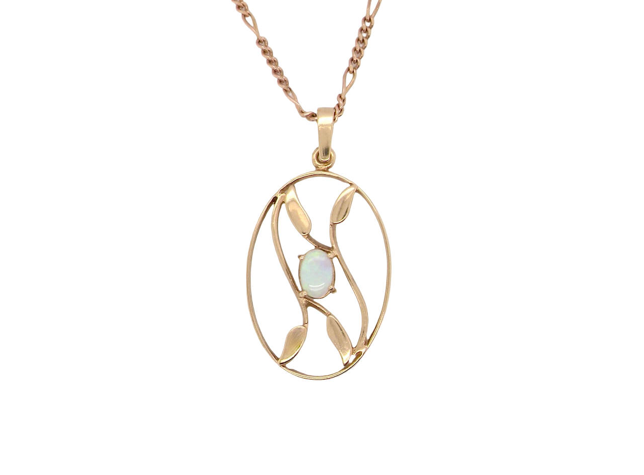 An elegant Art Deco style pendant featuring a beautiful oval opal measuring 6 × 4 mm,