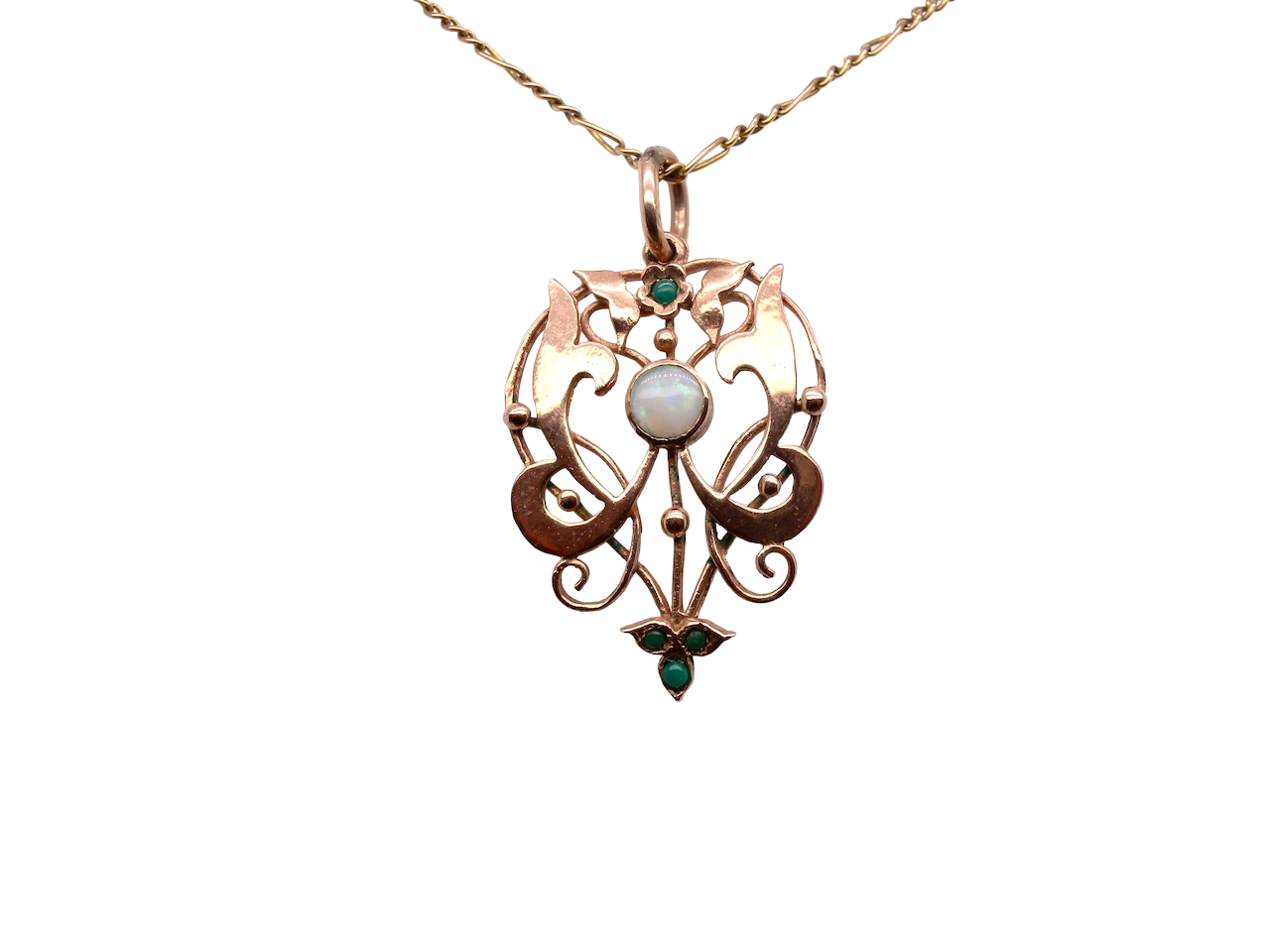 An elegant Edwardian-style pendant featuring a fancy openwork design, set with a round 5mm opal centre stone.
