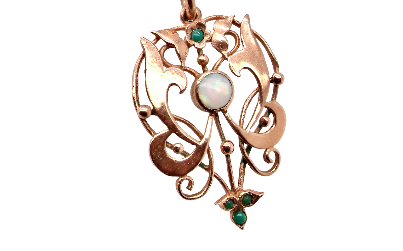 close view An elegant Edwardian-style pendant featuring a fancy openwork design, set with a round 5mm opal centre stone.