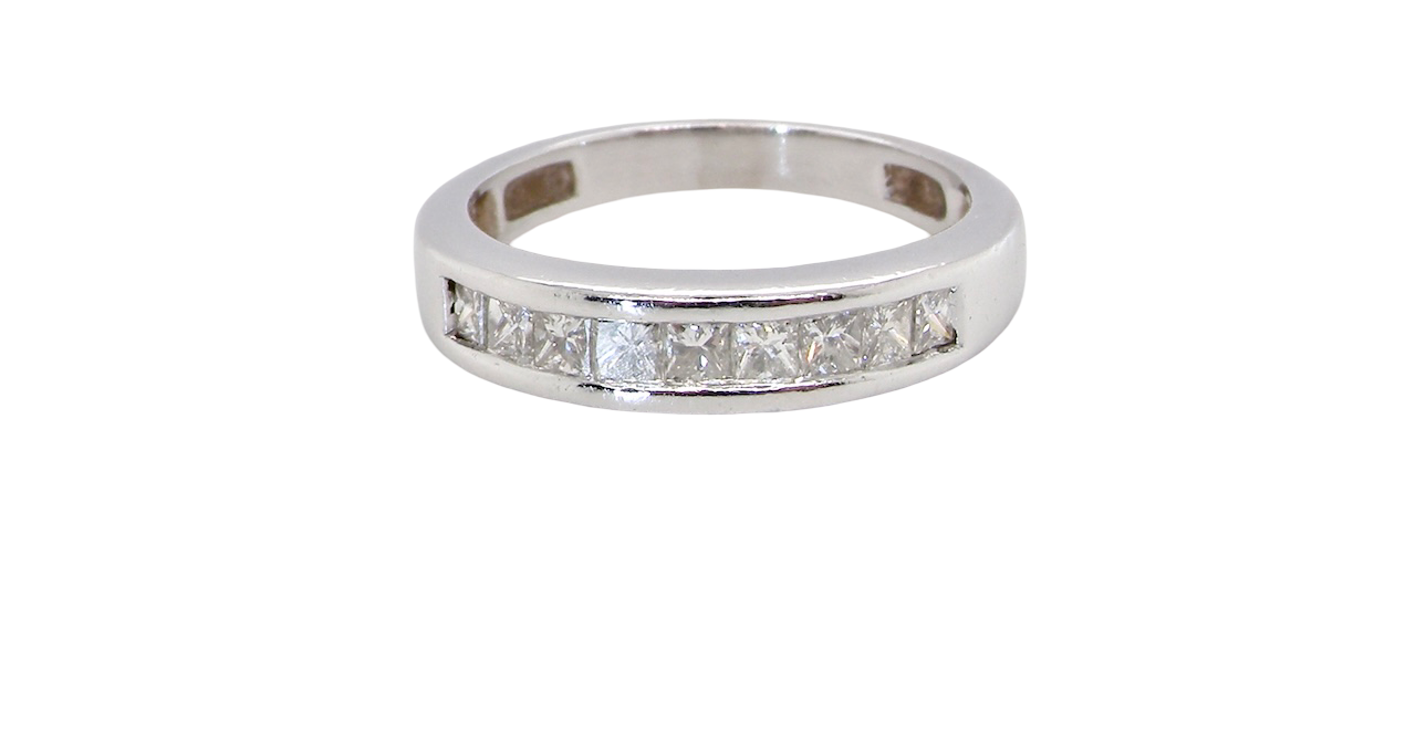 An elegant half-hoop eternity ring set with nine princess-cut white diamonds, each measuring approximately 2.5mm, with a total estimated diamond weight of 0.90 carats.